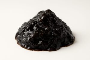 Close-up view of shilajit resin on a white background